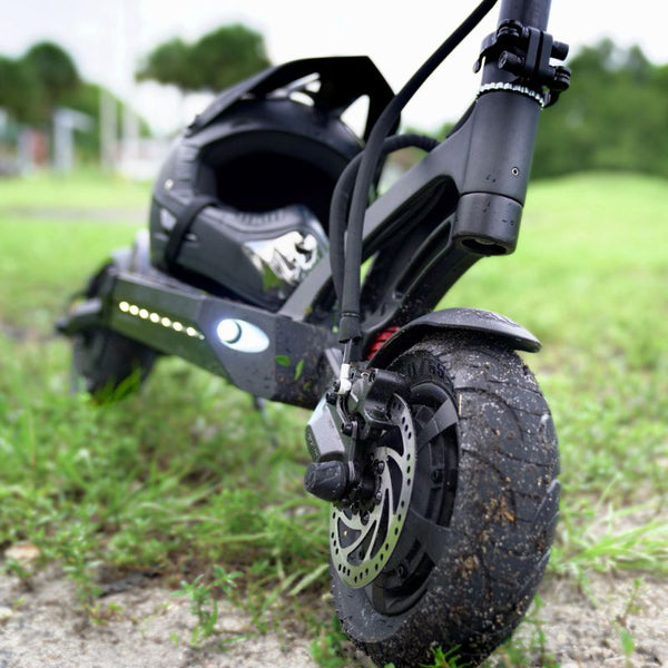 Mantis 40 MPH electric scooter parked with a helmet resting on the deck